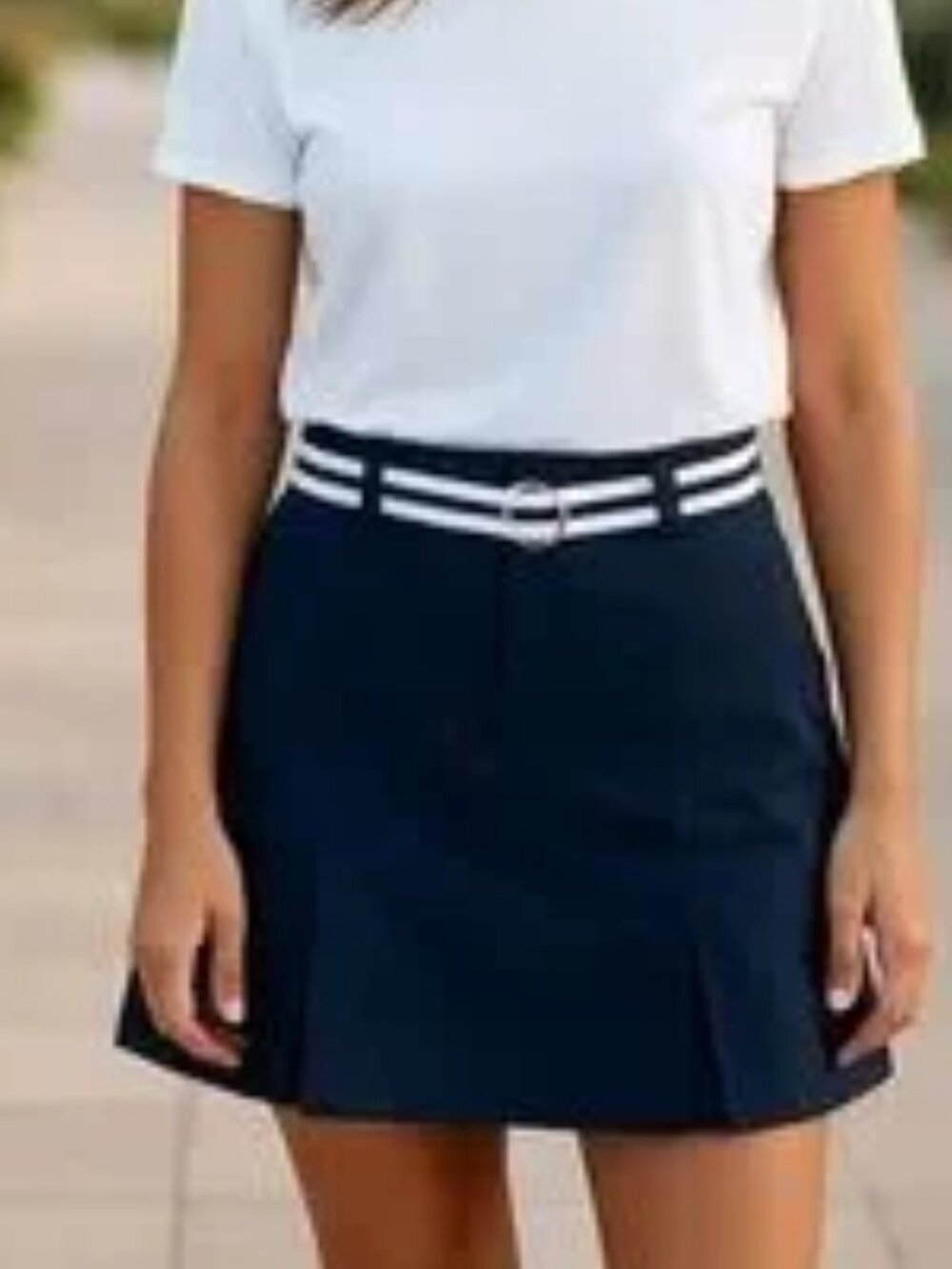 Navy blue skort with white and blue belt